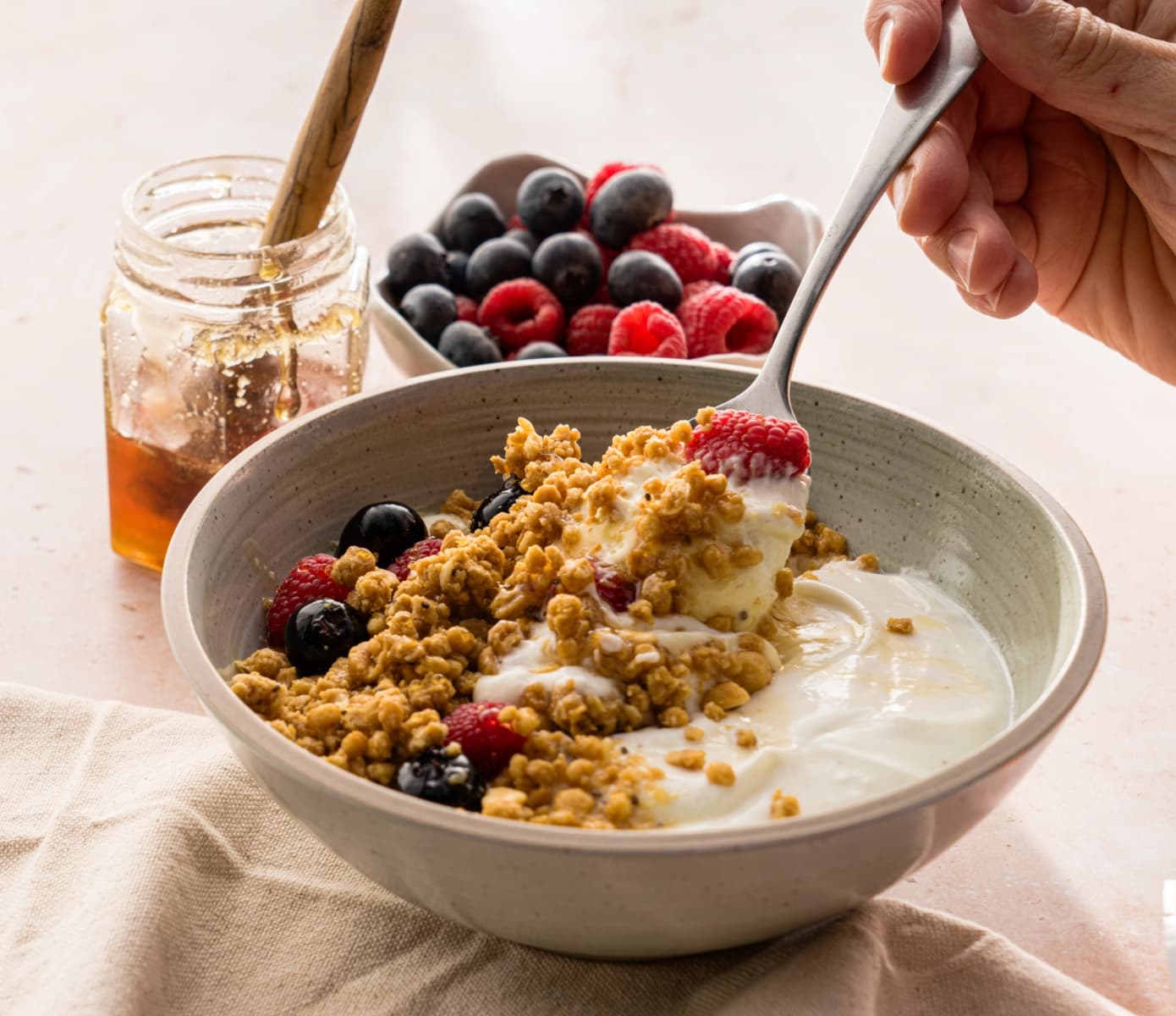 Bowl of yogurt topped with PBfit Protein Granola and berries