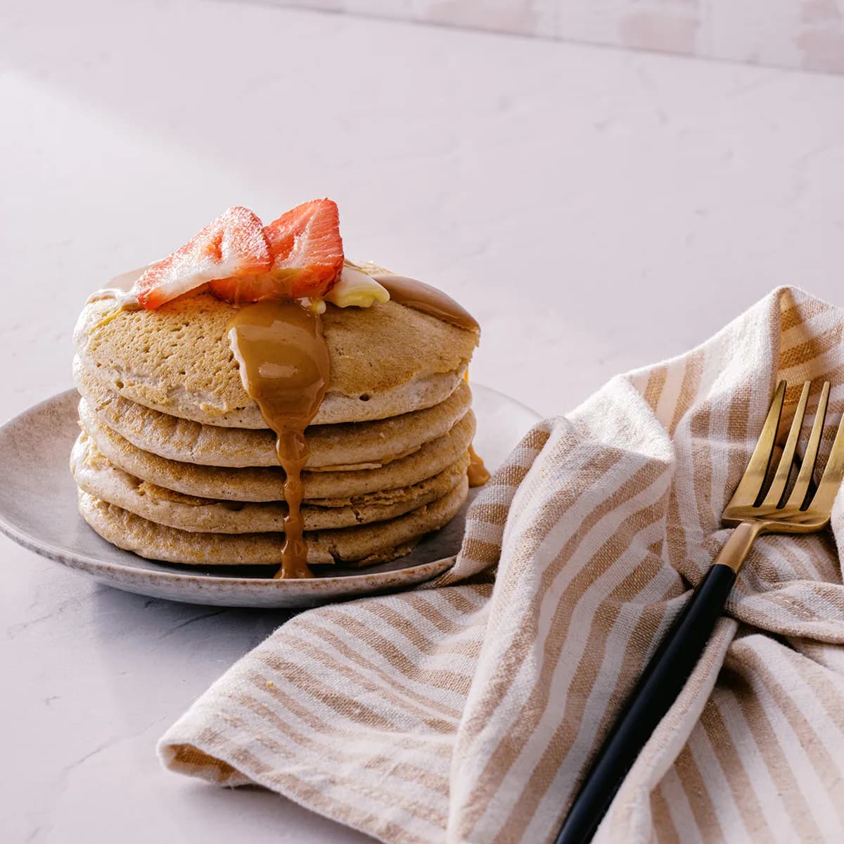 Stack of pancakes with PBfit No Sugar Added drizzled on top