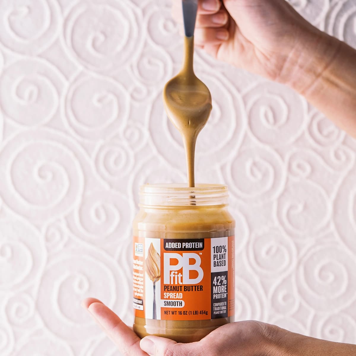 Spoon scooping PBfit Protein Peanut Butter Spread